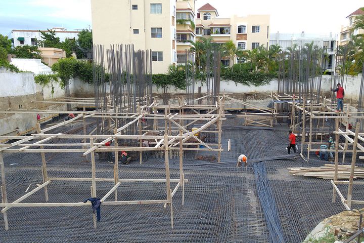 Timber formwork and a steel rebar mat set up on the foundation slab, before the concrete pour